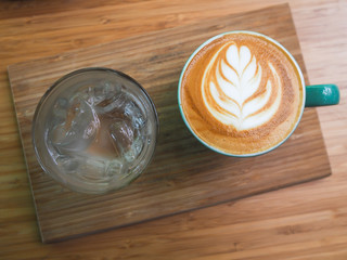 Hot cappuccino latte art on wood table