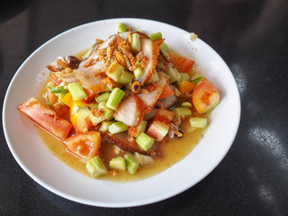 Traditional thai cuisine spicy green papaya salad with grilled pork