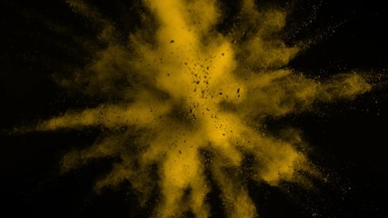 Super slowmotion shot of yellow powder explosion isolated on black background.