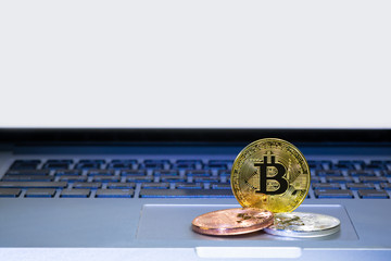 Bitcoin coins on laptop computer track pad