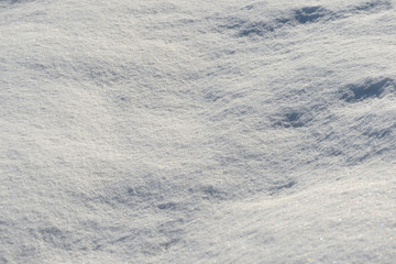 White snow texture on a sunny day. Winter background
