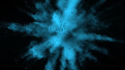 Super slowmotion shot of blue powder explosion isolated on black background.