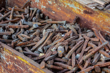 heap of rusty railroad spikes