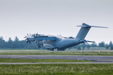 Fototapeta na wymiar Heavy military transport turboprop aircraft touching the runway