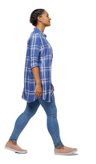 Side view of a young black girl walking in jeans and a checkered shirt.