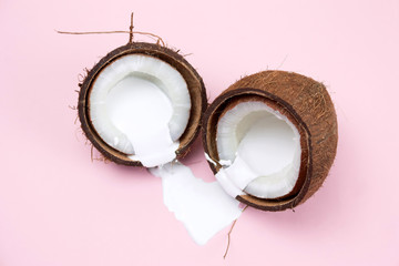 coconut with white liquid pain on a vibrant pink background