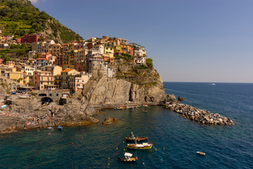 Fototapeta na wymiar Italy, Cinque Terre, Manarola, Cinque Terre, a body of water with Cinque Terre in the background