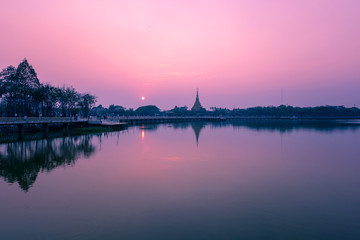 Fototapeta na wymiar Beautiful lighting of Wat Nong Wang temple and reflection on the water at Khonkaen province,Thailand.