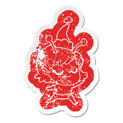 smiling alien girl cartoon distressed sticker of a wearing santa hat