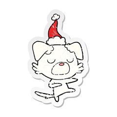 distressed sticker cartoon of a dog wearing santa hat
