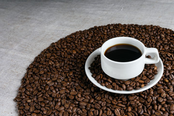 Coffee cup and beans on old kitchen table.