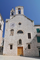 Fototapeta na wymiar Croatia, Sibenik, Church of St Barbara with bell tower and clock.