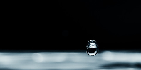 Water droplet splash backgound texture isolated on black. Fresh clean pure water ripples and splashes.  