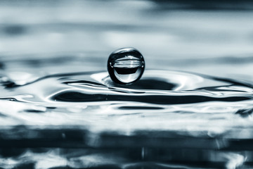 Fototapeta na wymiar Water droplet splash backgound texture isolated on black. Fresh clean pure water ripples and splashes. 