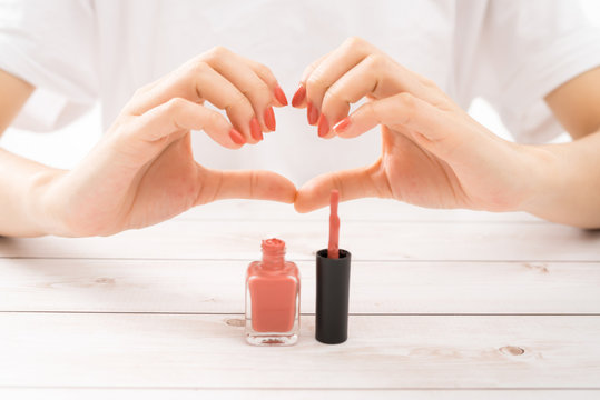 Beautiful women hands perfect red nails doing heart