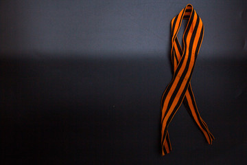 Obraz na płótnie Canvas St. George Ribbon, war ribbon, orange and black color, black background