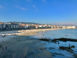 View of a typical beach day during a sunny summer in Sanxenxo Galicia Spain