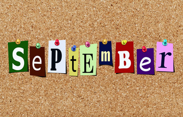 The september magazine cutout letters pinned to cork noticeboard - obrazy, fototapety, plakaty
