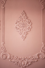 Wall with stucco pink. With the molding in a classic style.