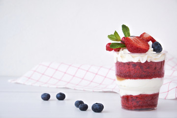 Cake dessert. Trifle red velvet in glass with fresh berry, mint leaves.
