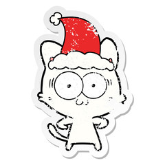 distressed sticker cartoon of a surprised cat wearing santa hat