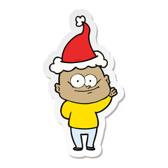 sticker cartoon of a bald man staring wearing santa hat