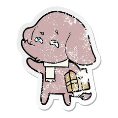 distressed sticker of a cartoon elephant with gift remembering