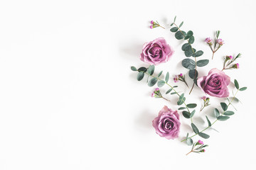 Flowers composition. Pattern made of eucalyptus branches and rose flowers on white background. Flat...
