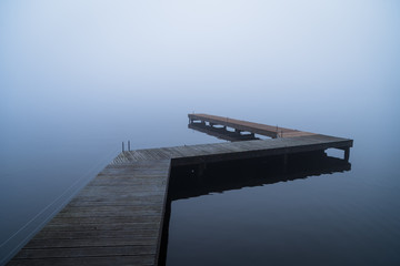 Depressed emotions concept: an empty jetty, on a foggy, winters morning.