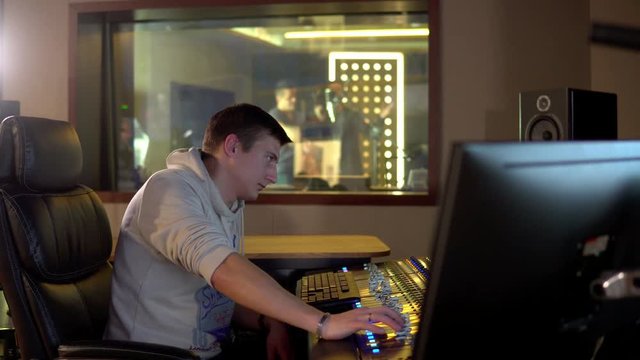 A man works in a recording studio