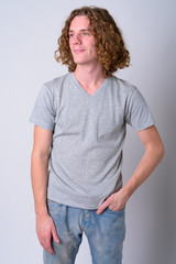 Portrait of young handsome man with curly hair thinking