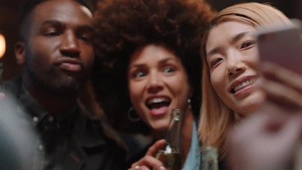 happy friends posing for photo using smartphone celebrating sharing celebration party on social media enjoying making memories together