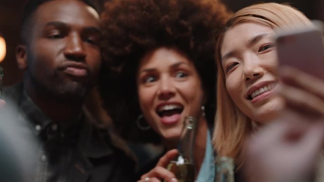 happy friends posing for photo using smartphone celebrating sharing celebration party on social media enjoying making memories together