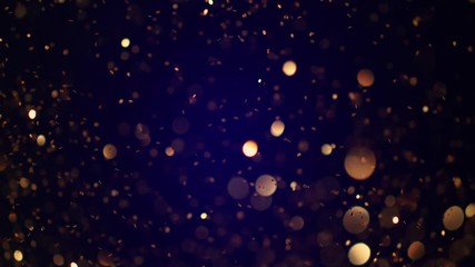Golden glitter explosion in super slow motion on blue background.