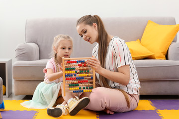 Little girl learning to count at private teacher's office