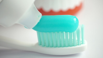 Fototapeta na wymiar Toothbrush and toothpaste on blurred background, closeup