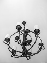 Vintage black chandelier with white candles