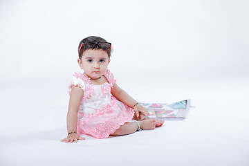 Indian Little Girl with note book , studying 