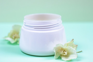 Fototapeta na wymiar Natural cosmetic products on a blue background..A jar of natural cosmetic cream