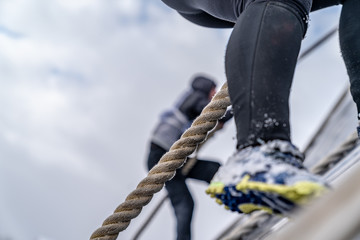 A man climbs an obstacle at a sporting event