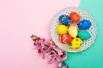 easter eggs on plate on colour background