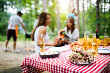 Friends making barbecue and having lunch in the nature