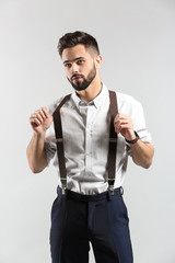 Fashionable young man on light background