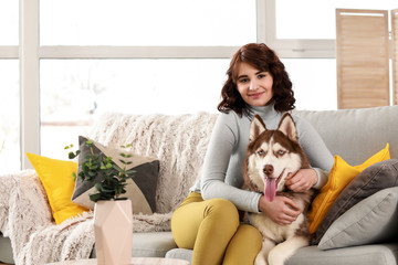 Young woman with her cute dog at home