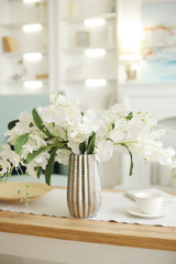 Light classic living room interior. coffee table and white orchid in vaz. A bright sunny day