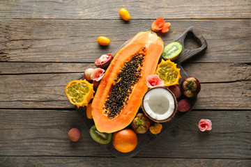 Assortment of tasty exotic fruits on wooden table