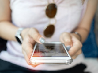 Woman's hand using smartphone