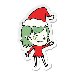 sticker cartoon of a friendly vampire girl wearing santa hat
