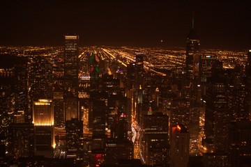 Downtown Chicago cityscape with skyscrapers, high rise buildings and light streaks under dark black night skyline