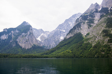 Fototapeta na wymiar Large stone mountains in the Alps on Konigssee Lake